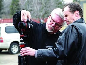 Jim Whitesell (left) works with Peter Etches to set up a camera with a panoramic lens to capture a 360 degree view of the Sherwood Park and District Chamber of Commerce building. The two photographers are a part of a global team organized by Google to digitalize businesses around the world. Leah Germain/Sherwood Park News/QMI Agency
