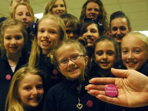 Competitive dancers from On Your Toes dance studio handed out buttons during a recent dance competition. The buttons read "simply amazing," and were handed out to their competitors or those working behind the stages to put the competition on. 
TARA BOWIE / SENTINEL-REVIEW / QMI AGENCY