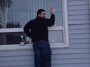 Rob Perrotta (past president of Rotaract Club of North Bay) washed windows during Saturday's Day of Giving. Teams of Rotarians and Rotaractors pitched in to help those unable to complete tasks on their own.