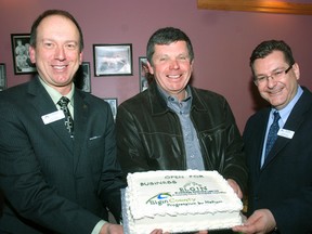 John Regan, left, general manager of the Elgin Business Resource Centre, holds a cake celeberating the opening of a satellite office in Dutton with Cameron McWilliam, ‌county warden and mayor of Dutton/Dunwich and Mark Masseo of EBRC, who will staff the office.