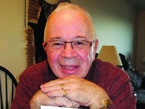 INSIDER: Vern Tibedeau poses with a copy of his book about prison life.