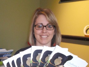 Lisa Caron of HUB Creative Group in Chatham, on. displays the hot-off-the-press copies of the 2013-14 Chatham-Kent Travel Guide on April,9, 2013. (BOB BOUGHNER/ THE CHATHAM DAILY NEWS/ QMI AGENCY)