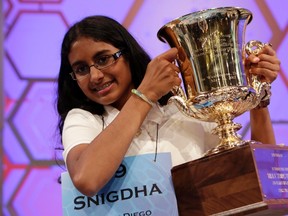 Snigdha Nandipati, 14, of San Diego, California, holds her trophy after winning the Scripps National Spelling Bee at National Harbor in Maryland in this file photo taken May 31, 2012. Young contestants at the Scripps National Spelling Bee will face a new challenge this year by not only having to spell obscure words, but to know what they mean.  (REUTERS/Kevin Lamarque/Files)