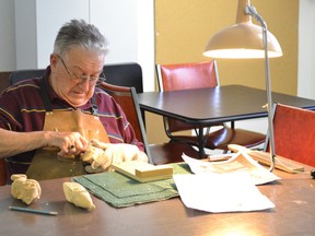 Pictured is Ian Evans, adding more details to his Elf on a Shelf.