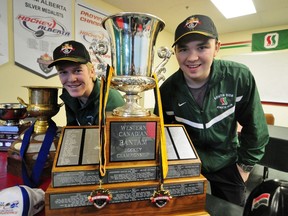 Southside Athletic Club (SSAC) star forward Tyler Benson, left, and team captain David Quenneville pose alongside the 2013 Western Canadian AAA Bantam Championship trophy at the SSAC Clubhouse, 4250 - 91A st., on Monday. The Lions captured their first Western Championship last weekend defeating Team B.C. 5-3 in Kindersley, SK. TREVOR ROBB Edmonton Examiner