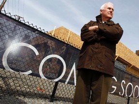 Michael Rowan poses by the sales office for a new condo development at the corner of Carling Ave. and Preston St. in Ottawa's Little Italy Tuesday, April 9, 2013. The development, which is a few hundred feet from Rowan's home, is a 42-storey mixed-use residential and commercial with about 250 units and 263 parking spaces.  
Darren Brown/Ottawa Sun/QMI Agency