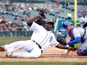 Tigers' Torii Hunter is tagged out at homeplate by Toronto Blue Jays catcher J.P. Arencibia during the third inning in Detroit on Tuesday. (REUTERS/ Rebecca Cook)