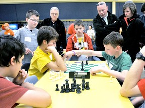 Lucas Piorro, 11, left, contemplates his next move as opponent Zackary Lewis, 12, advances his chess piece during the Chatham Chess Challenge, Tuesday. PHOTO TAKEN Chatham, On., Tuesday April 09 2013. DIANA MARTIN/ THE CHATHAM DAILY NEWS/ QMI AGENCY