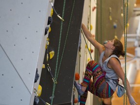 Bow Valley competitive climber Allison Vest tries her hand at one of the routes on Elevation Place’s climbing wall during the team’s first practice session in the new facility on Monday.