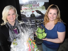 SARAH DOKTOR Times-Reformer
Chantal Zorad, special events coordinator, and Jessica Vanderschee, staff member, with the Norfolk County Fair show off some of the items that will be available during the silent auction at Eat & Drink Norfolk this weekend at the Aud in Simcoe.