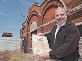 BRIAN THOMPSON, The Expositor

Rob Adlam, past-president of the Canadian Industrial Heritage Centre, holds a replica of a scroll made at the completion of the Cockshutt Plow Co. complex on Mohawk Street more than 100 years ago.  Efforts are underway to negotiate a lease with the city so that the CIHC can use the timekeeper's building and remaining portico in the creation of an interpretive centre showcasing Brantford's manufacturing history.