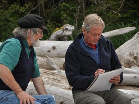 Mark Hobson, left, and Robert Bateman share sketches during an expedition sponsored and organized by Raincoast Conservation Foundation to depict the biodiversity and integrated, ecological elements of the forest, intertidal, and ocean zones, and the people, flora and fauna that have lived there for thousands of years. Submitted photo.