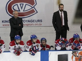 Kingston Voyageurs players along with, from left, trainer Rick Ewart, general manager Denis Duchesne and coach Colin Birkas look on dejectedly after the Newmarket Hurricanes scored in the second overtime period to win Game 7 of the Ontario Junior Hockey League North-East Conference championship series 3-2 on Monday night at the Invista Centre. (Ian MacAlpine/The Whig-Standard)