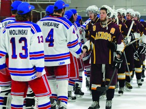 Members of the Athens Aeros, including Daniel Lacroix (9) and Pat Cameron (19) shake hands with the victorious Ottawa Jr. Canadians following game four of the EOJHL final. The Canadians took the game 5-2 to win the league championship in four games. (SUBMITTED PHOTO Phil Kall)