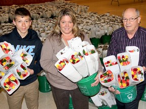 Ellwood Shreve photo:
Quinn Cannella, 15, left, and Chatham Sunrise Rotary members Toni Martin and John Lawrence display the beautiful roses the local service club is delivering on Wednesday across Chatham-Kent.