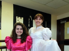 Paris District High School Grade 11 students Maggie Kyle, left, and Christine Muresan model two dresses for Operation Cinderella, an annual initiative to collect prom dresses and suits for students in Brant county and Brantford who might not otherwise go to their Grade 8 proms. Michael Peeling/The Paris Star