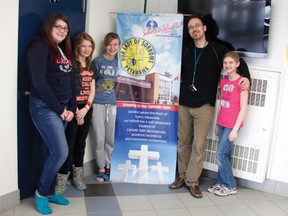 MYRIAM LUBLINK
From left: Eryn Buchanan,  Catherine Bell, Morgan Campbell and Julia Tedford, Grade 6 students, work with their teacher Mark Sokolski to get Our Lady of Sorrows Catholic School in Petawawa into first place in the Majesta Trees of Knowledge competition by voting at www.majestatreesofknowledge.ca. The school is currently in second place and is hoping with the support of the community they will move into the lead across Canada.