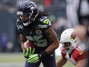 Seattle Seahawks' Richard Sherman (25) intercepts a pass meant for Arizona Cardinals' Larry Fitzgerald (11), returning it for a touchdown during the second quarter of their NFL football game in Seattle, Washington, December 9, 2012. (REUTERS/Robert Sorbo)