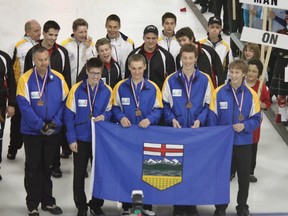 Photo submitted
Team Alberta holds the provincial flag, with the bronze medals around the players’ necks. In the background are gold medalists Team Manitoba and silver medalists Team Ontario.