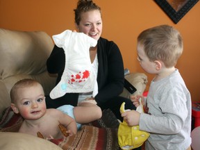 Timmins mother Rachel Gervais gets some help from her son, three-year-old Max, right, as one-year-old Felix waits to be fitted with a fresh cloth diaper featuring a maple leaf design. Gervais will be one of nearly 100 parents taking part in the Great Cloth Diaper Change world record breaking attempt on Saturday, April 20.