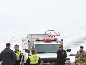 Emergency crews waits to see if they would be called upon the free this vehicle stuck in Ghost Lake.