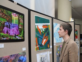 Rhys Emms has a look at student artwork at GPRC on Tuesday. The artwork is on display all week at the college. (Patrick Callan/Daily Herald-Tribune)