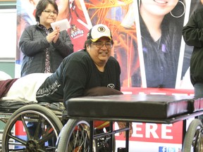 Gordon Mianscum is all smiles as he looks at his new custom-fitted wheel bed Wednesday afternoon at Canadore College. Several community services agencies helped raised the $8,500 for the device.