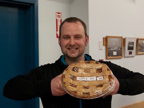Malcolm Thiessen holds up his prized win, an apple pie, won at Friday’s David Thompson Bible Camp Pie Auction.