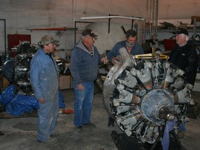 The Fairview Aircraft Restoration Society members, left to right, Don Wieben, John Campbell, Jim Allan and Doug Roy with one of the engines they will be taking to Newfoundland.