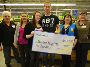 The parents of a young child waiting for a heart transplant since last July accept a cheque from Walmart for $5,000. From left Kathy Deveney, Christina House, Tania and Brian Klingenberg, Sandra Robertson and Melissa McCrea. HEATHER RIVERS/WOODSTOCK SENTINEL-REVIEW