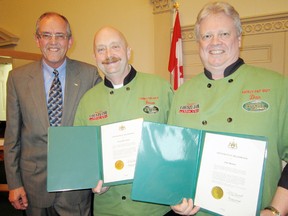 MONTE SONNENBERG Simcoe Reformer
The Two Fairly Fat Guys – Dan Barker of Simcoe, right, and Brian Reichheld, centre, of Jarvis – were officially recognized at Norfolk council this week as the county’s Local Food Ambassadors. Presenting the pair with citations for outstanding volunteer service was Windham Coun. Jim Oliver, left, deputy mayor of Norfolk.