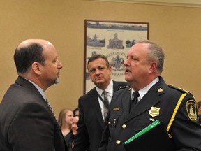 Sgt. Paul Legault, left, of the Ontario Provincial Police's municipal policing bureau, speaks to Brockville Police Chief John Gardiner, right, before Wednesday's finance, administration and operations committee meeting. Listening in, at centre, is the OPP's East Region director of operations, Supt. Carson Pardy. The chief and his OPP counterparts expressed mutual respect despite potentially being at odds over the future of policing in Brockville. RONALD ZAJAC The Recorder and Times