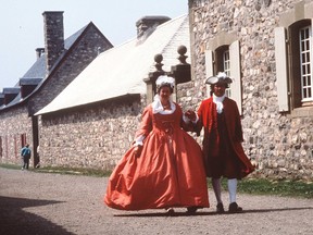 A pair of costumed interpreters walk at the Fortress at Louisbourg.