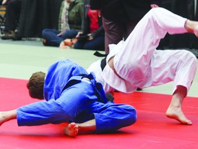 Fort Saskatchewan fighter Colton Hall (blue) takes down his opponent at last weekend’s international judo tournament at the West Edmonton Mall Ice Palace. Hall, along with fellow Fort resident Alexandra Gagnon, brought home the gold over the weekend.

Photo by Aaron Taylor/Fort Saskatchewan Record/QMI Agency