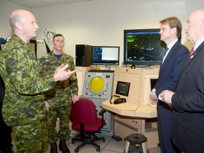 Lt. Col. Colin Selkirk, commanding officer of Aerospace and Telecommunications Engineering Support Squadron (ATESS) at 8 Wing/CFB Trenton, and Sgt. Wes Henderson, radar expert, speak to Chris Alexander, Parliamentary Secretary to the Minister of National Defence and Ajax MP and Northumberland-Quinte West MP Rick Norlock regarding ATESS radar systems following a funding announcement at the base Thursday, April 11, 2013.
EMILY MOUNTNEY/TRENTONIAN/QMI AGENCY