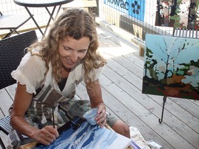 Holly Friesen puts some finishing touches on an oil painting during the Lake of the Woods Arts Community’s Open Studio Tour in July 2012. LOWAC has received $98,000 over two years from the Ontario Trillium Foundation to hire someone to help develop the city's arts scene.