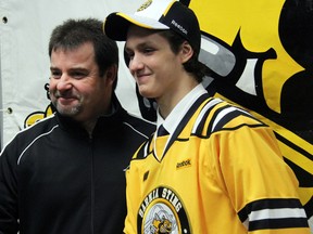 Nikita Korostelev, right, the Sarnia Sting's first round draft pick in the 2013 OHL Priority Selection, shakes hands with Sting head coach and general manager Jacques Beaulieu. (PAUL OWEN, The Observer)