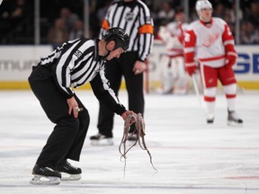 An NHL referee picks up an octopus that was thrown onto the ice during a game last season. Throwing octopi onto the ice is a tradition in Detroit. (File photo)
