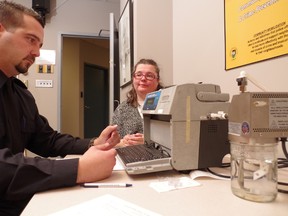 Const. Darren Corcoran, of the Sault Ste. Marie Police Service (left), administers a blood-alcohol test on Sandra Turco.