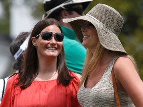 Skier Lindsey Vonn (R), girlfriend of Tiger Woods, looks on with physical therapist Lindsay Winninger during first round play in the 2013 Masters golf tournament at the Augusta National Golf Club in Augusta, Georgia, April 11, 2013. (REUTERS/Mike Segar)