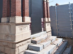 BRIAN THOMPSON, The Expositor

The portico of the now-demolished Cockshutt Plow Co. warehouse and timekeeper's building on Mohawk Street sits behind a protective aluminum fence.  The Canadian Industrial Heritage Centre hopes to include the remaining structures in the creation of an interpretive centre.