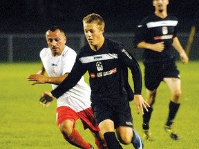 A member of the 2012 Woodstock Stallions pushes the ball up field against the White Eagles SC last August at Cowan Park. The Woodstock Stallions are in the First Division of the Western Ontario Soccer League this season and are hoping a re-connect with the Woodstock Soccer Club will keep local players in Woodstock and give them long-term success. (Sentinel-Review file photo)