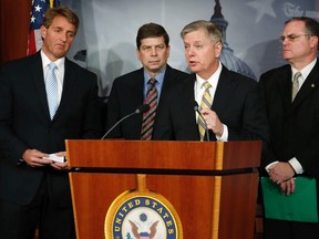 U.S. Senator Lindsey Graham (second from right) speaks as he leads Senator Jeff Flake (left), Senator Mark Begich (second from left) and Senator Mark Pryor (right) in a news conference about proposed gun violence legislation at the U.S. Capitol in Washington March 6, 2013. (REUTERS/Jonathan Ernst)
