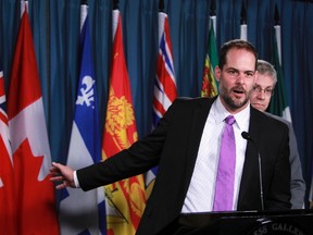 NDP deputy critic Alexandre Boulerice points to a Canadian flag alongside ethics critic Charlie Angus as he speaks to the media at Parliament Hill in Ottawa, Sept. 18, 2012. (ANDRE FORGET/QMI AGENCY)