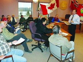 Paul Moreau, the county’s director of property and development (right), answers Deep River residents‘ questions concerning the location of a new land ambulance base scheduled to be constructed this spring on Banting Drive.