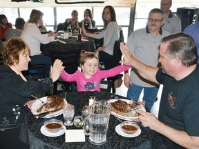 Algoma-Manitoulin MPP Michael Mantha and Algoma-Manitoulin-Kapuskasing MP Carol Hughes get a high-five from five-year-old Ilsa Bertand-Gendron. Ilsa is a past assistance recipient from the North Shore Cruisers Sick Kids Fund. Photo by: KEVIN McSHEFFREY/THE STANDARD/QMI AGENCY