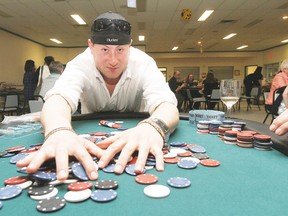 Adam Kjorlien rakes in his winning pot at the poker table during the Millet Fun Money Casino at the Agriplex April 6.