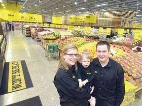 Franchisees Jessica and Craig Posthumus and their daughter Abigail welcomed shoppers to the new No Frills grocery story that opened Friday in the city's west end. (SCOTT WISHART, The Beacon Herald)
