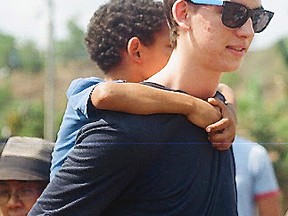 SCITS student Cooper Davis-Draper spends some time with youngsters during Rayjon's March Break Dominican Republic awareness trip.