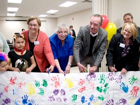 The official ribbon cutting on the new Family Resource Centre was cut in 2013 by (left to right): Dawn Froese, Big Brothers Big Sisters of Canada; Diane de Lucia, Child and Family Services Family Enhancement Program, Portage la Prairie Deputy Mayor Irvine Ferris and Cathy Vanstone, Tupper Street Family Resource Centre. (CLARISE KLASSEN/PORTAGE DAILY GRAPHIC/QMI AGENCY)
